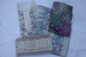 Embroidered fabric pieces with floral patterns on a white background